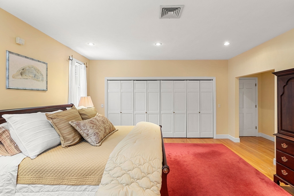 3 Stone Road Boxford, MA 01921 - Photo 21 of 40 a bedroom with a large bed and a large mirror