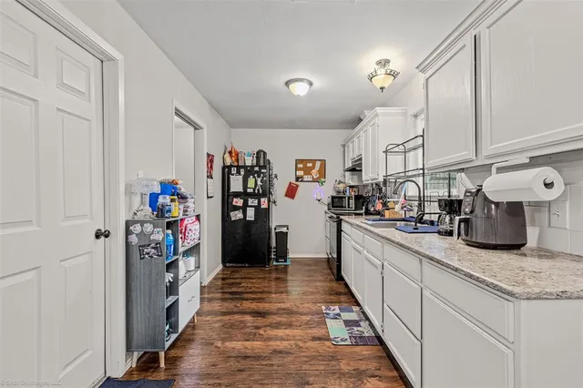a kitchen with refrigerator and cabinets