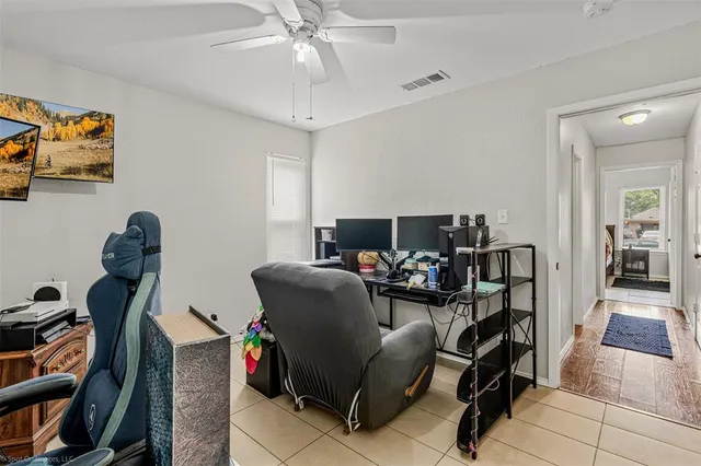 a living room with furniture a piano and a bookshelf