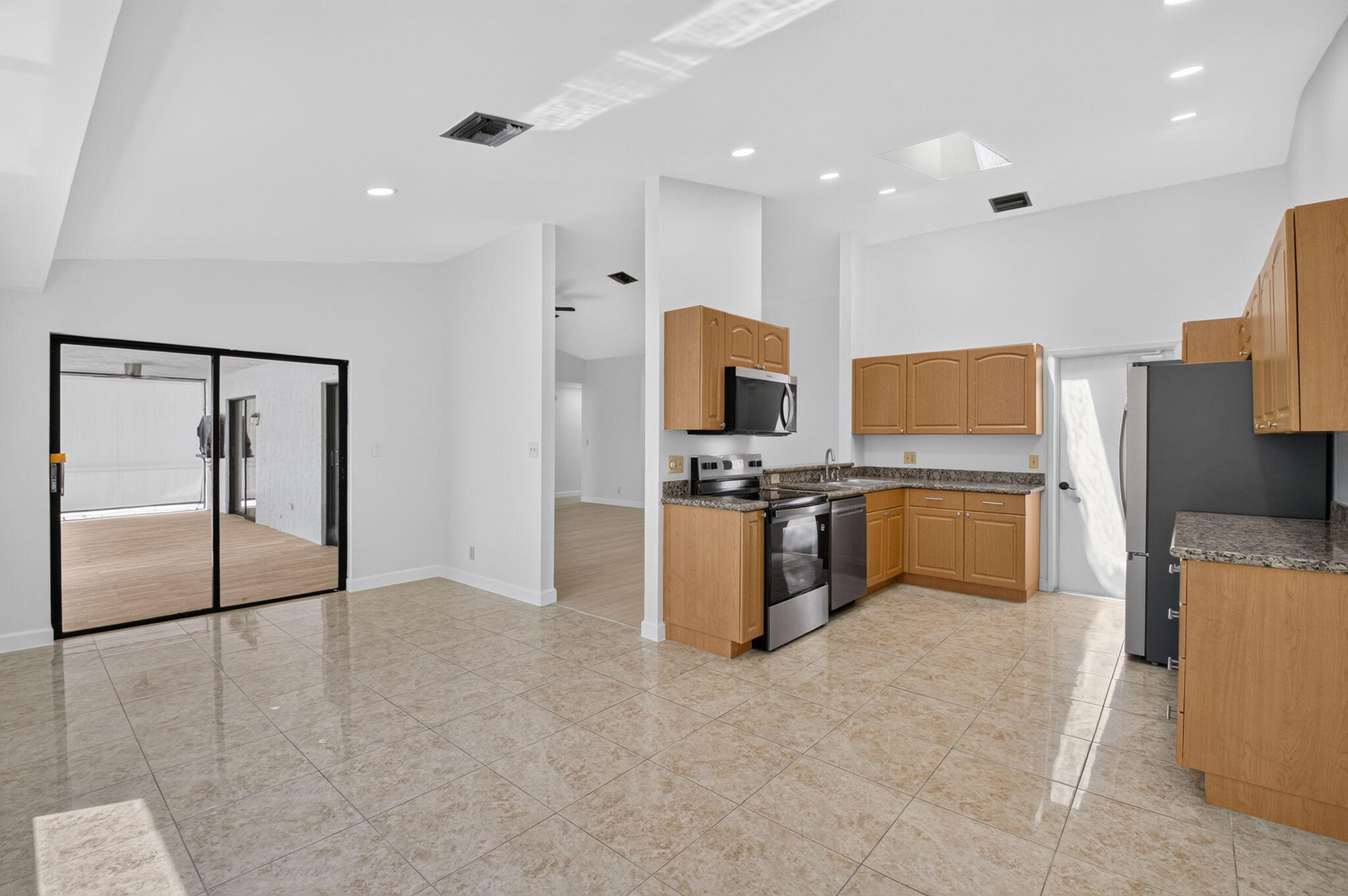 21070 Woodspring Avenue Boca Raton, FL 33428 - Photo 10 of 30 a kitchen with cabinets and steel stainless steel appliances