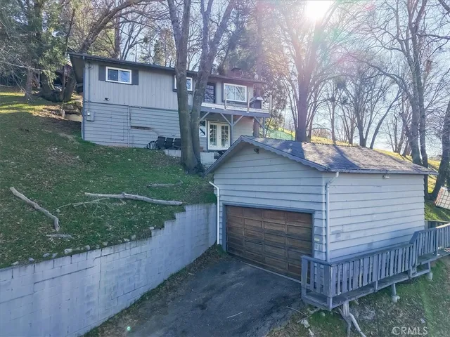 a view of a wooden house with a yard