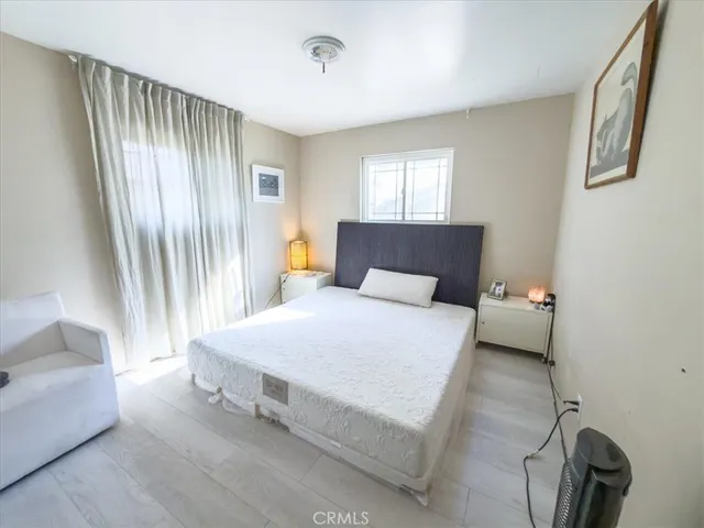 a bedroom with a bed and window