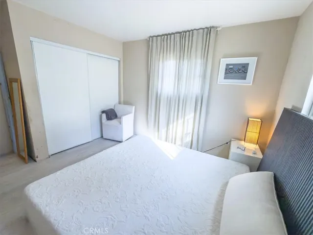 a bedroom with a bed and window