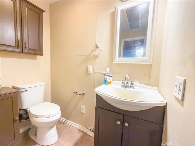 a bathroom with a sink a toilet and mirror