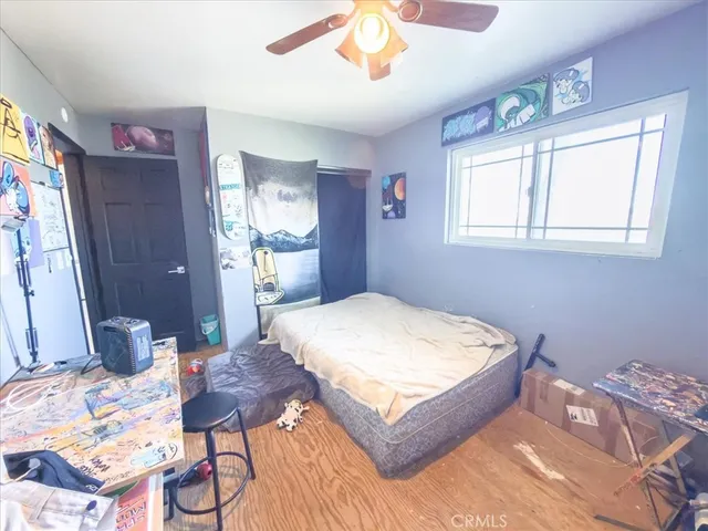 a bed sitting in a bedroom next to a window