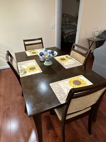 a view of a dining area with furniture and wooden floor