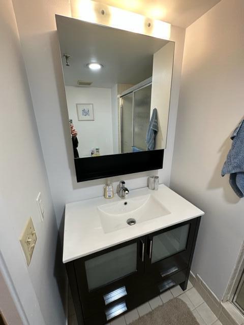 6500 Northwest 2nd Avenue, Unit 512 Boca Raton, FL 33487 - Photo 21 of 41 a bathroom with a sink a mirror and vanity