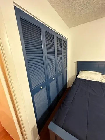 a living room with a flat screen tv and a toilet