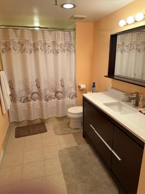 6500 Northwest 2nd Avenue, Unit 512 Boca Raton, FL 33487 - Photo 31 of 41 a bathroom with a sink a toilet and shower