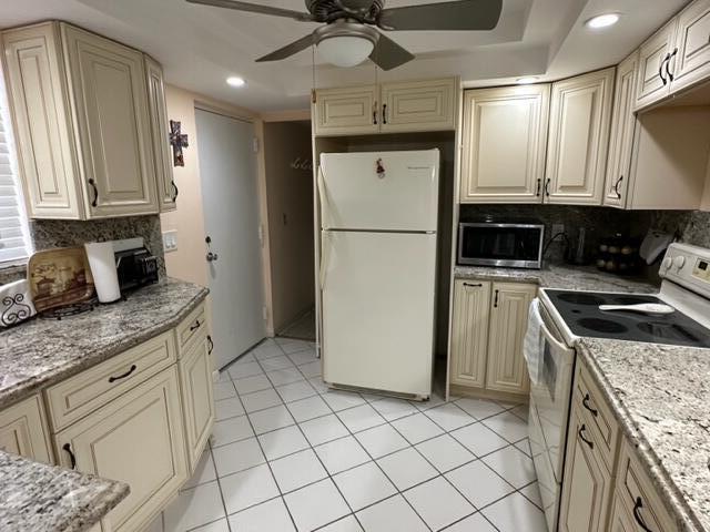 6500 Northwest 2nd Avenue, Unit 512 Boca Raton, FL 33487 - Photo 6 of 41 a kitchen with a sink a refrigerator and cabinets