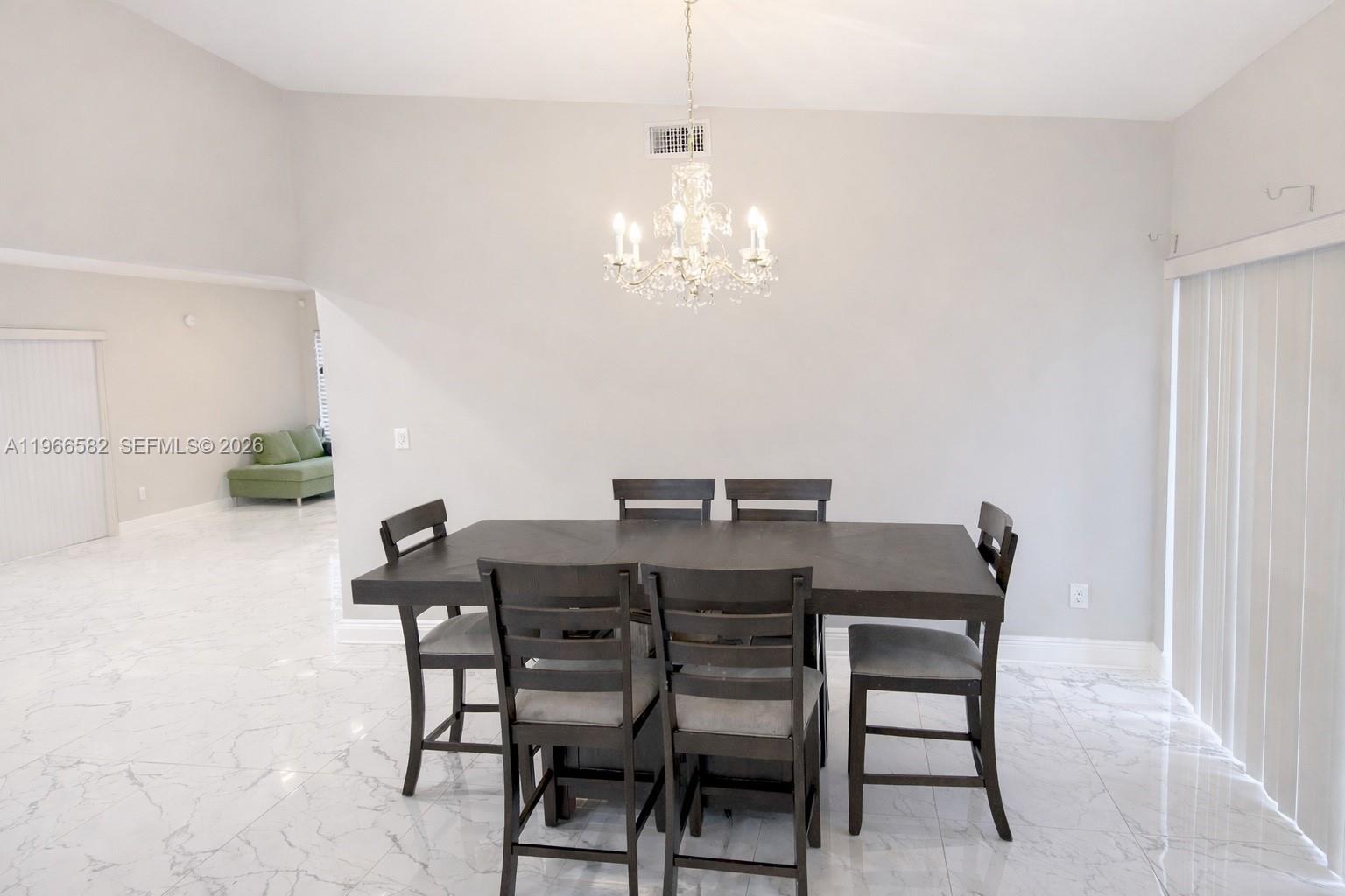 20888 Sugarloaf Lane Boca Raton, FL 33428 - Photo 13 of 25 a view of a dining room with furniture and chandelier