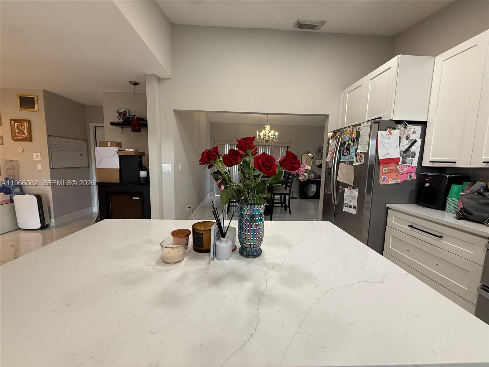 20888 Sugarloaf Lane Boca Raton, FL 33428 - Photo 24 of 25 a kitchen with a refrigerator and cabinets