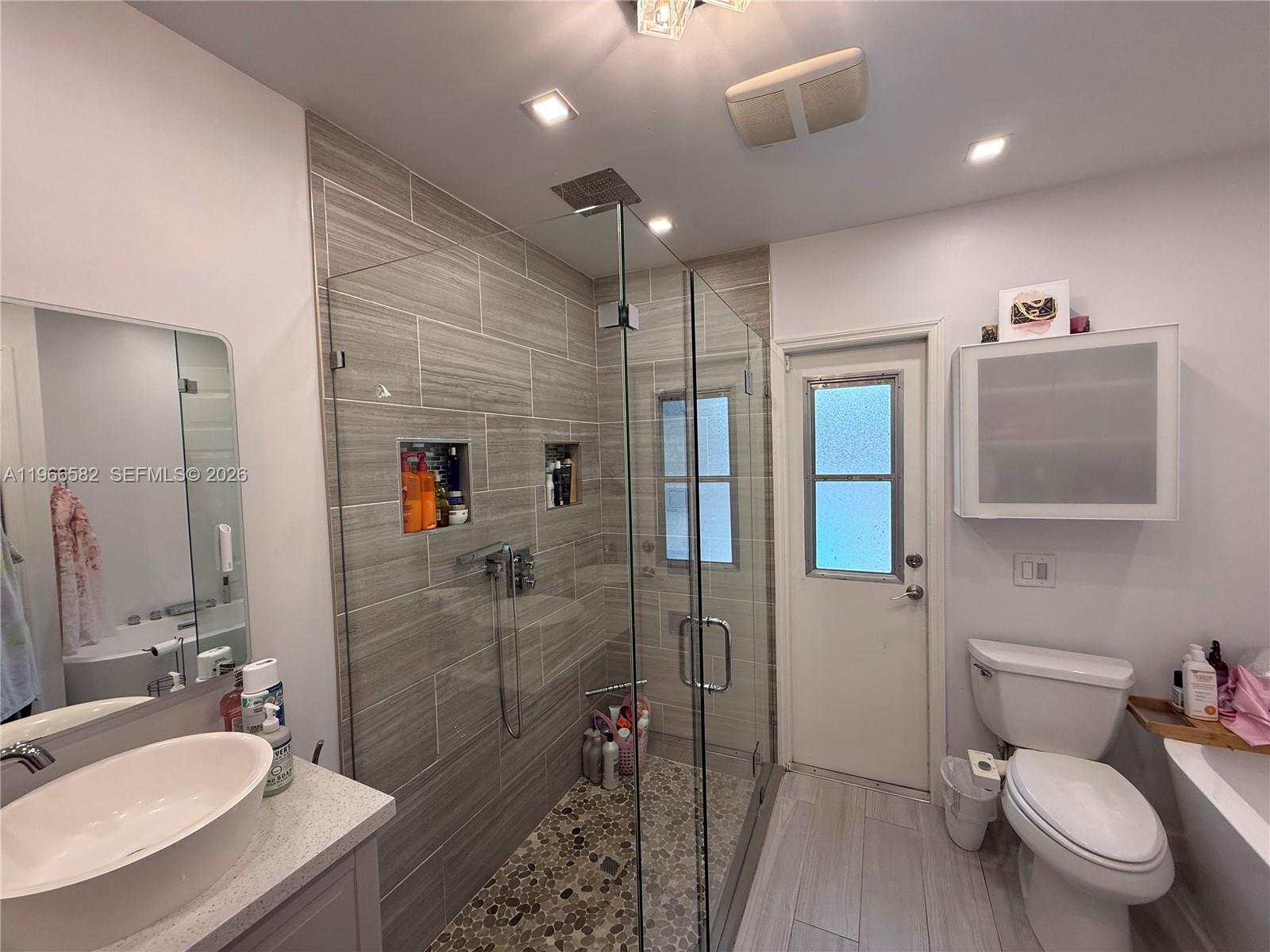 20888 Sugarloaf Lane Boca Raton, FL 33428 - Photo 7 of 25 a bathroom with a sink toilet and shower