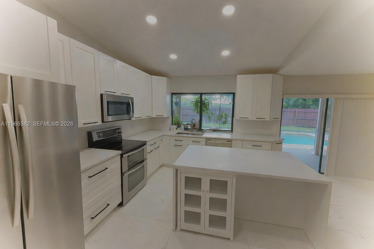 20888 Sugarloaf Lane Boca Raton, FL 33428 - Photo 9 of 25 a kitchen with stainless steel appliances a refrigerator sink and stove