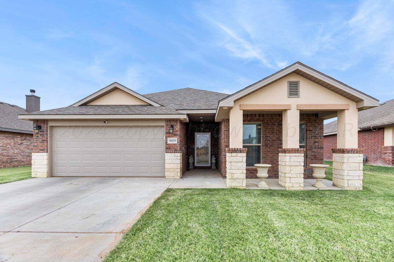 9609 Westin Drive Amarillo, TX 79119 - Photo 1 of 36 a front view of a house with a yard and garage