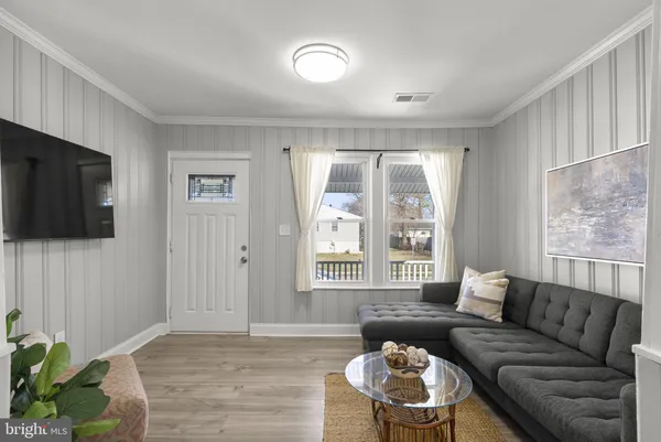 a bathroom with a sink a mirror a potted plant and bathtub