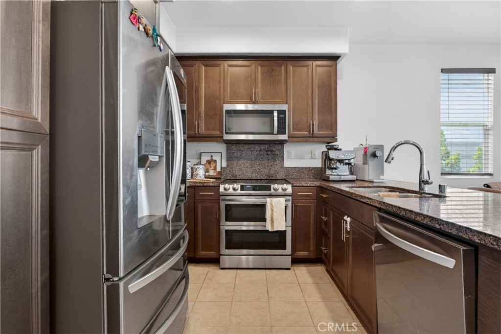 5796 Spring Street Buena Park, CA 90621 - Photo 10 of 33 a kitchen with a sink stove and microwave
