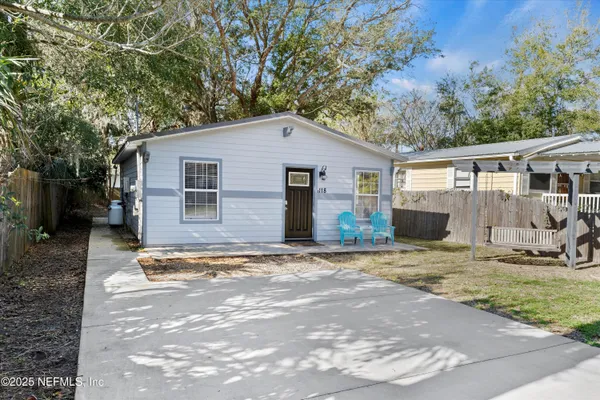 a kitchen with stainless steel appliances kitchen island granite countertop a table chairs sink and cabinets