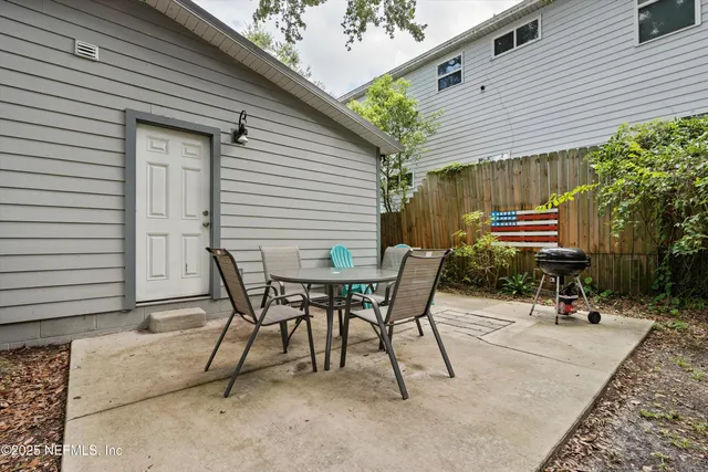 a view of a chairs and table in backyard of the house
