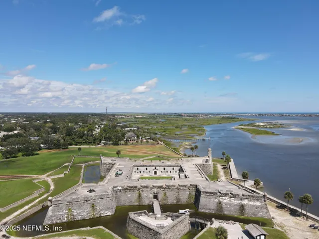 a view of a patio with table and chairs and potted plants