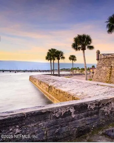 a view of a lake with lawn chairs