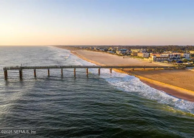 a view of roof deck with two chair and a potted plant