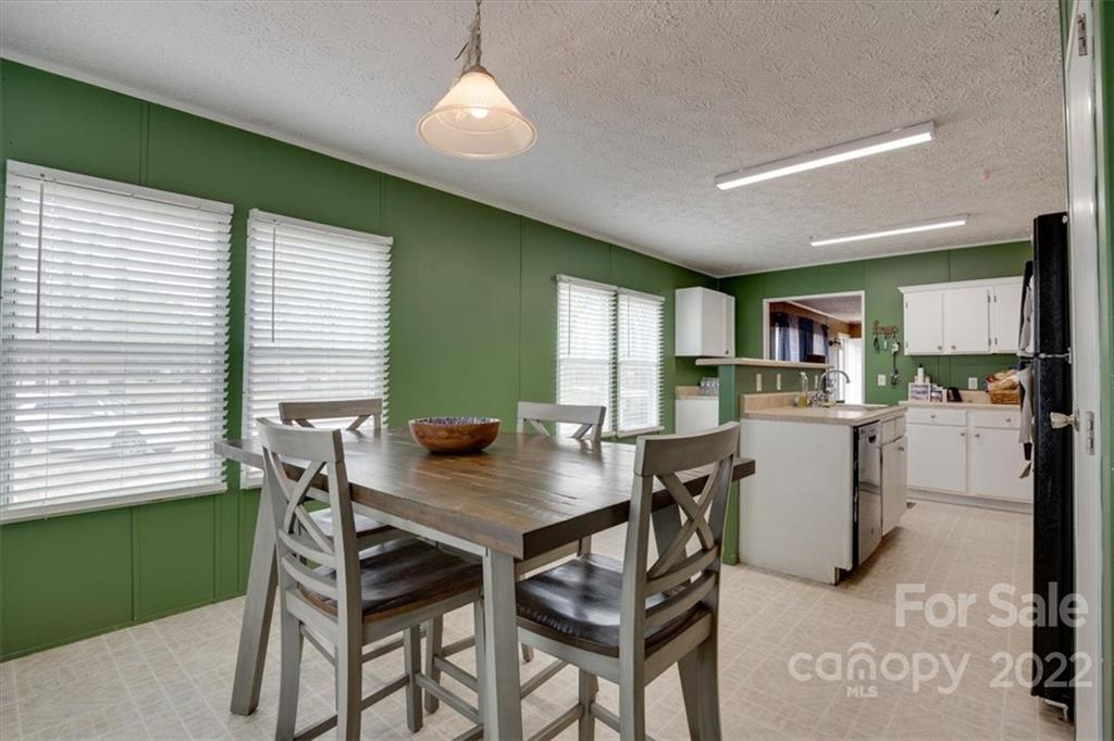2444 Campbell Lake Road Lancaster, SC 29720 - Photo 12 of 24 a view of a dining room with furniture and a kitchen