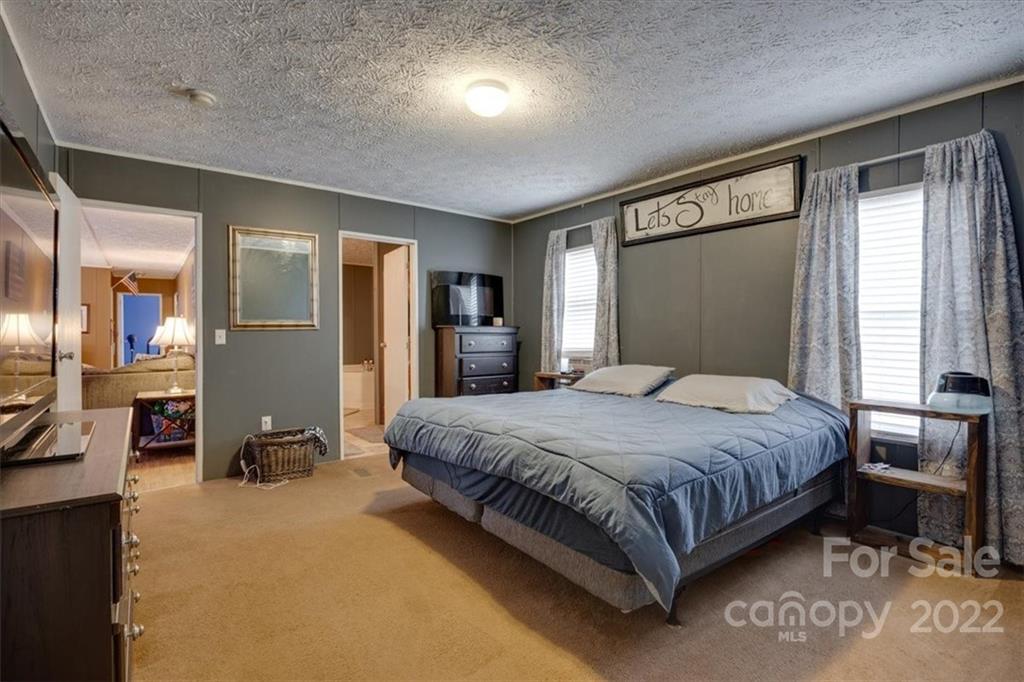 2444 Campbell Lake Road Lancaster, SC 29720 - Photo 15 of 24 a bedroom with a bed and a large mirror