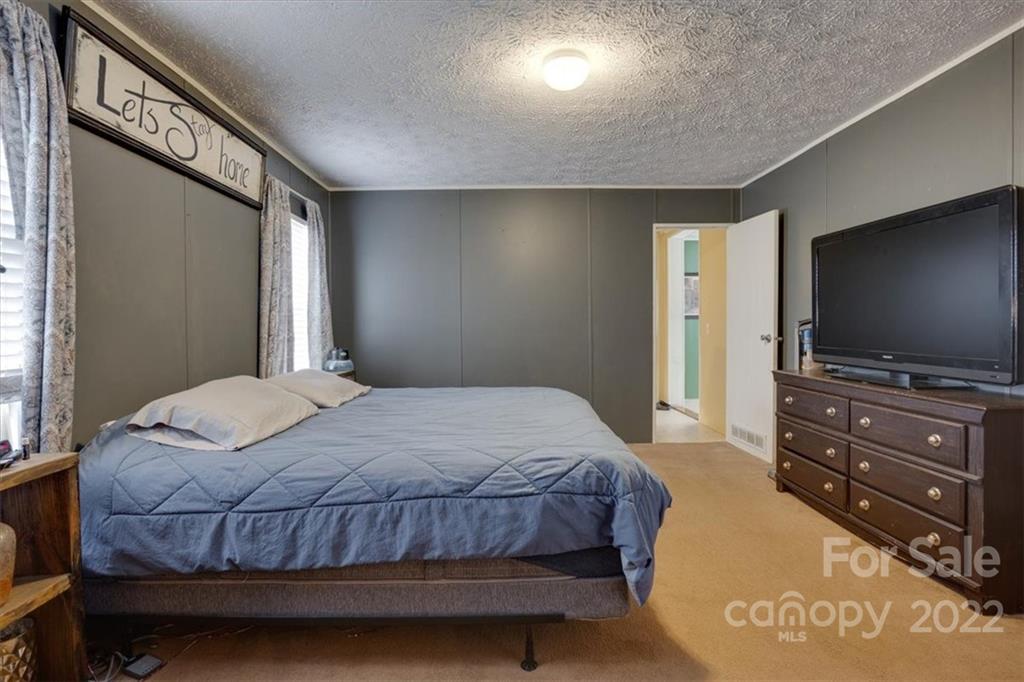 2444 Campbell Lake Road Lancaster, SC 29720 - Photo 16 of 24 a bedroom with a bed and a flat screen tv