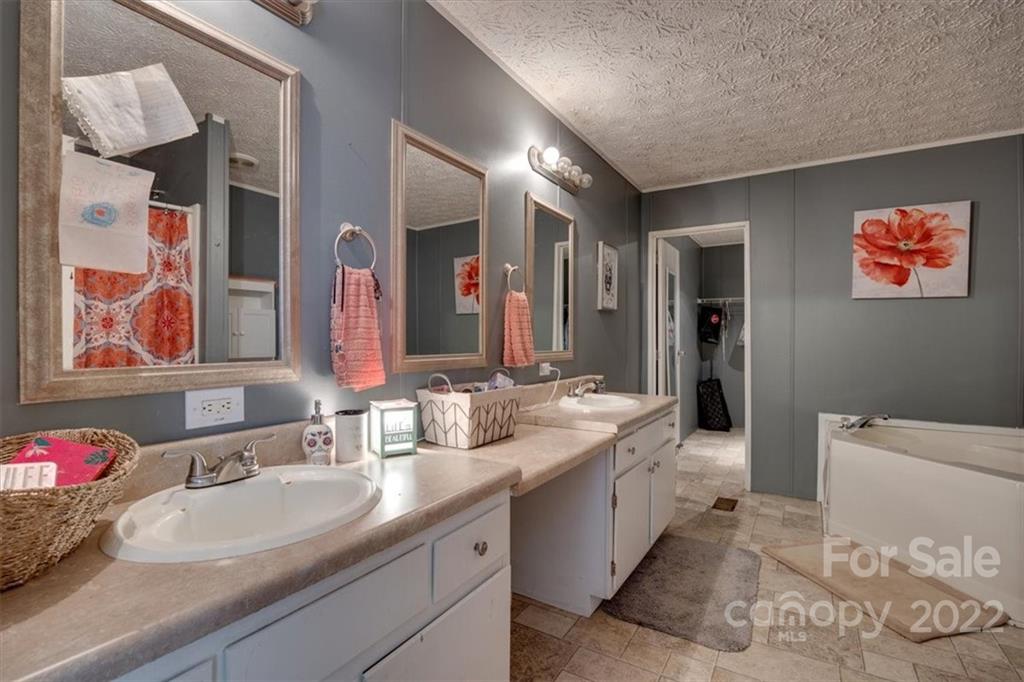 2444 Campbell Lake Road Lancaster, SC 29720 - Photo 17 of 24 a bathroom with a double vanity sink mirror and bathtub
