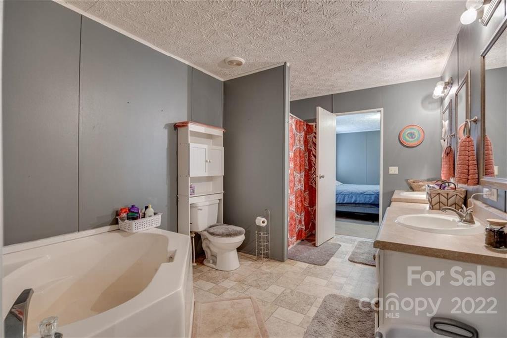 2444 Campbell Lake Road Lancaster, SC 29720 - Photo 18 of 24 a bathroom with a tub shower and sink
