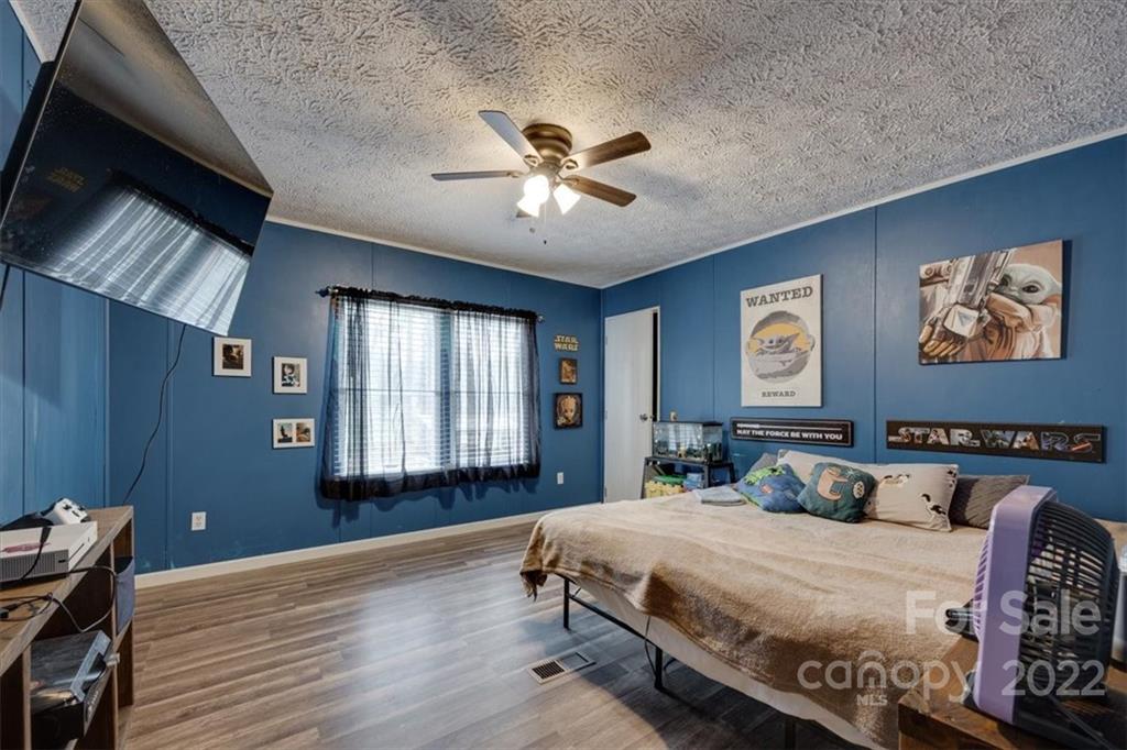 2444 Campbell Lake Road Lancaster, SC 29720 - Photo 19 of 24 a bedroom with a large bed and a chandelier