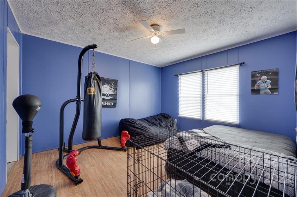2444 Campbell Lake Road Lancaster, SC 29720 - Photo 20 of 24 a bedroom with a bed and a chandelier