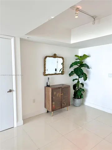a picture of a room with window and a potted plant