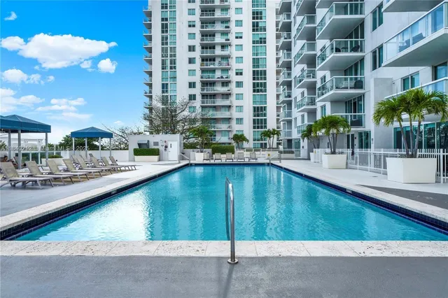 a swimming pool with outdoor seating and yard