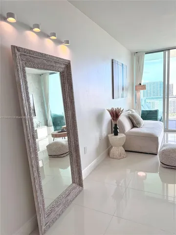 a living room with furniture and a mirror
