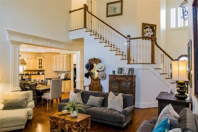 a living room with furniture and a chandelier