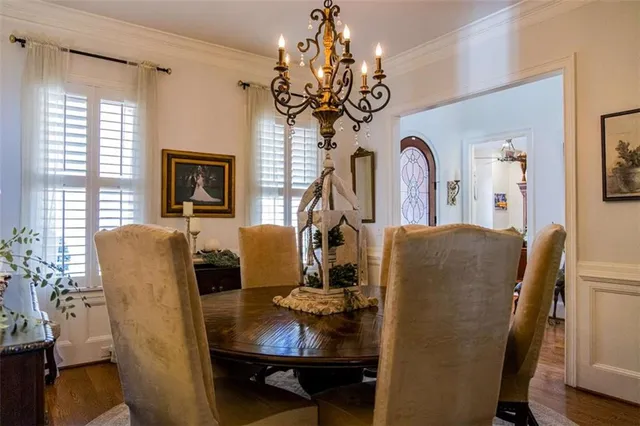 a dining room with furniture a chandelier and window