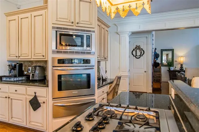 a kitchen with granite countertop a stove and a microwave