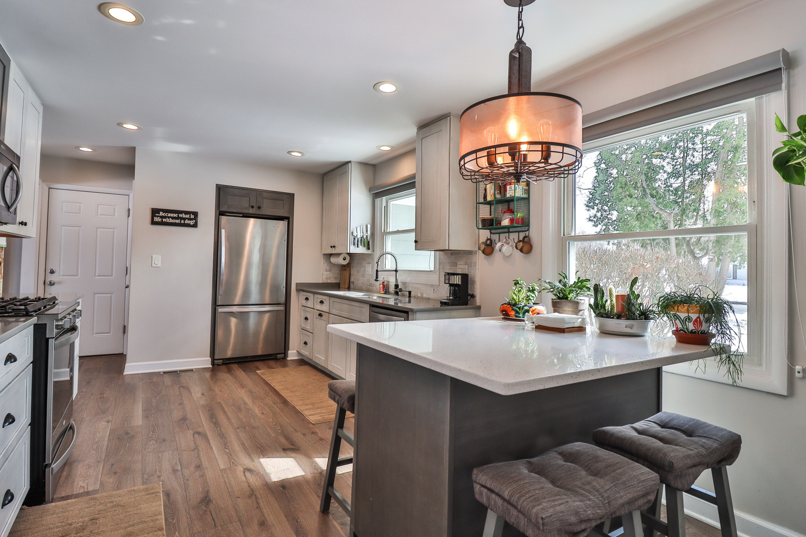 1920 North Washington Street Wheaton, IL 60187 - Photo 5 of 76 a kitchen with stainless steel appliances granite countertop a stove a refrigerator a sink dishwasher a dining table and chairs with wooden floor