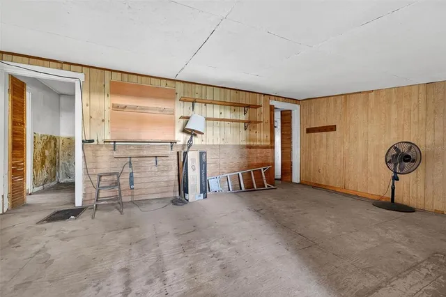 a view of empty room with wooden walls