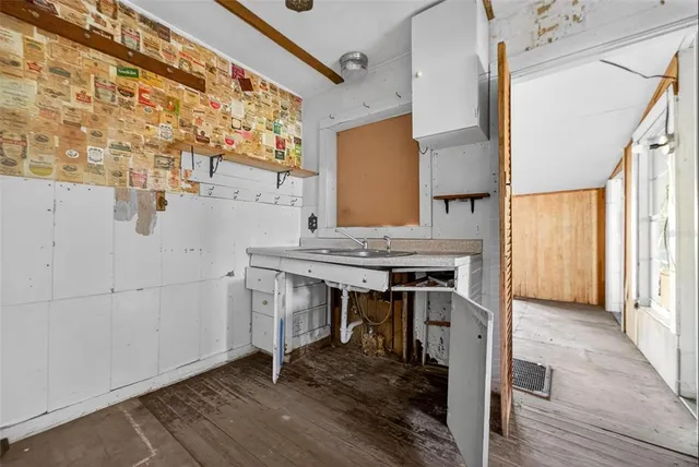 a view of a livingroom with a staircase and a sink