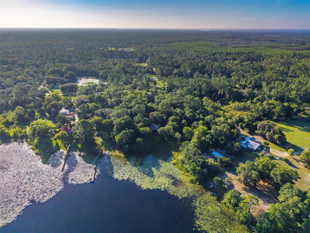 54544 Buckhorn Road Astor, FL 32102 - Photo 2 of 36 a view of a lake with a house