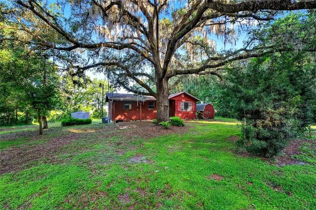 a view of house that has a yard