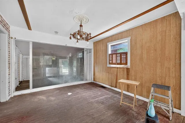 a view of a room with wooden floor and windows