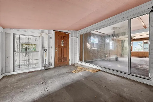 a view of an empty room with large windows