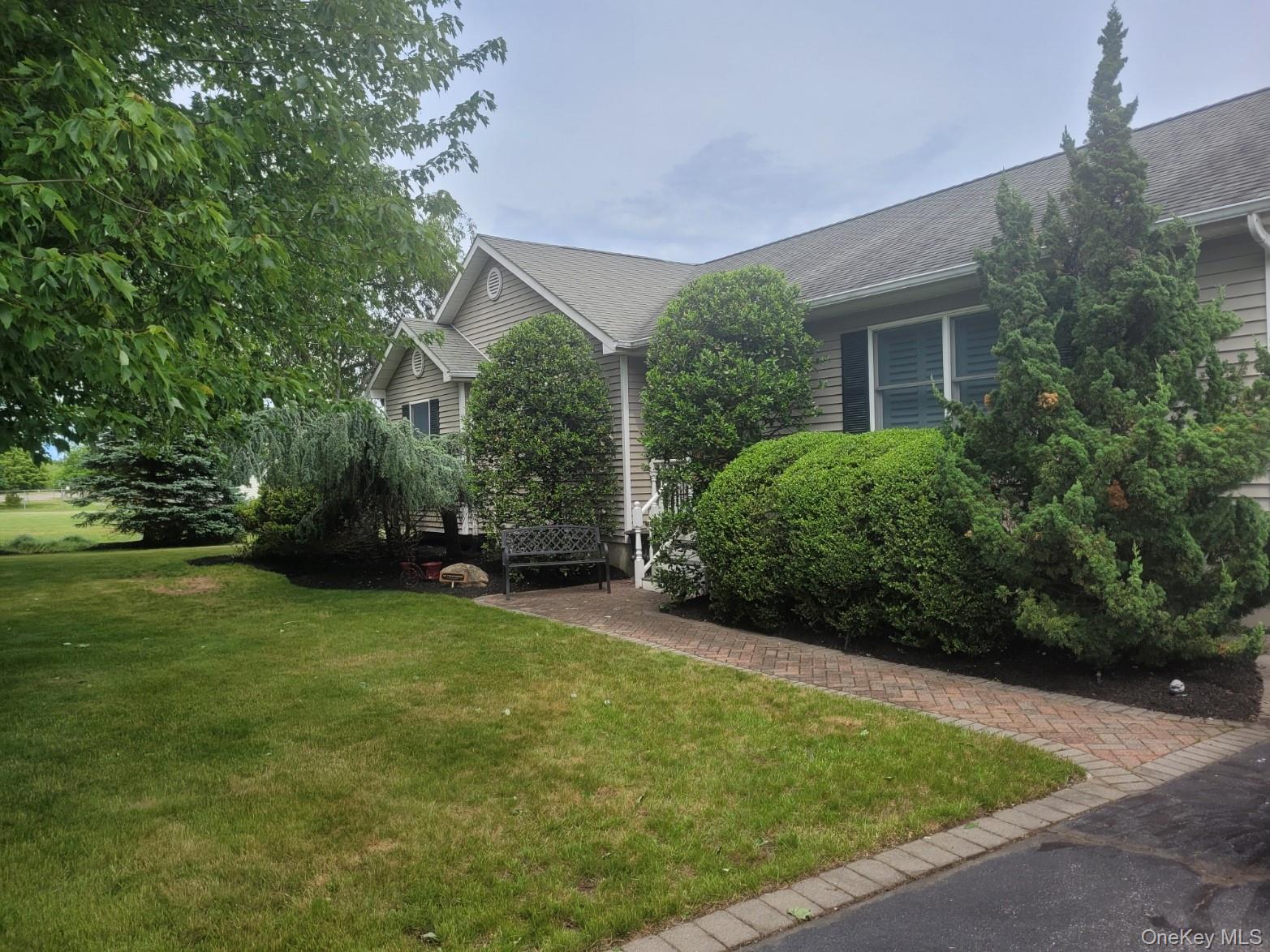 312 Riley Avenue Calverton, NY 11933 - Photo 2 of 30 Ranch-style exterior featuring horizontal siding, dark shutters, and a front porch with white railings