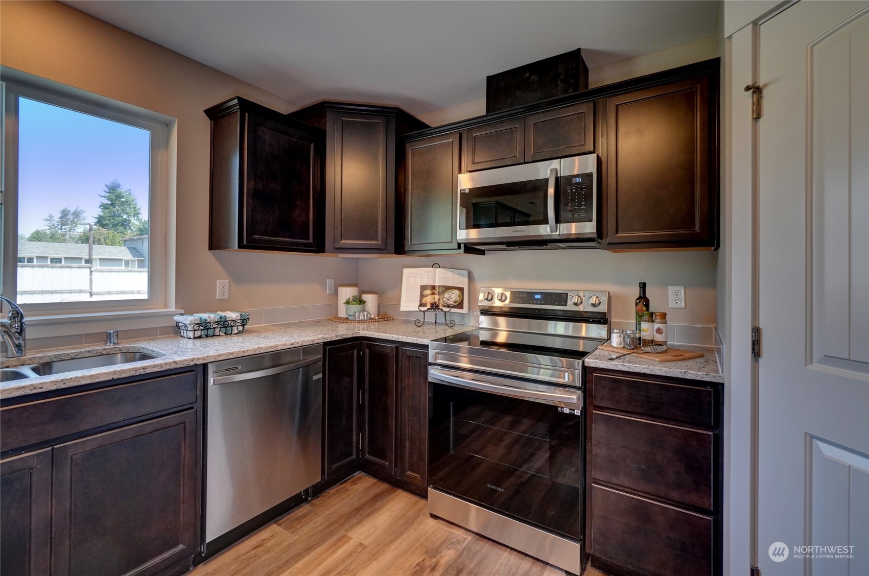 10705 36th Street East Edgewood, WA 98372 - Photo 14 of 40 a kitchen with stainless steel appliances a stove sink and microwave
