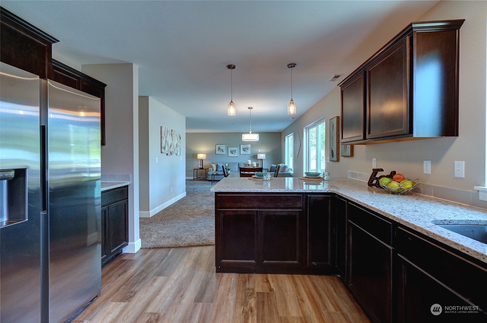 10705 36th Street East Edgewood, WA 98372 - Photo 16 of 40 a kitchen with stainless steel appliances granite countertop a refrigerator a sink and wooden cabinets
