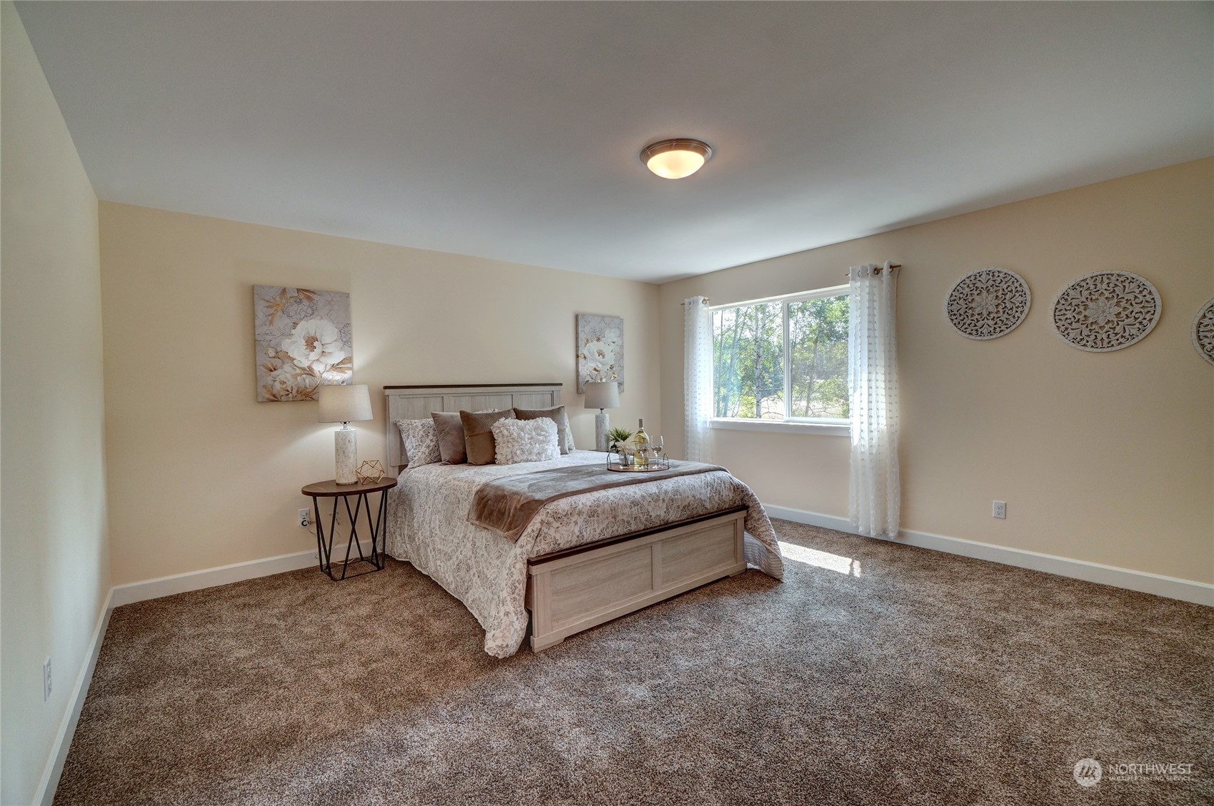 10705 36th Street East Edgewood, WA 98372 - Photo 19 of 40 a spacious bedroom with a bed and window